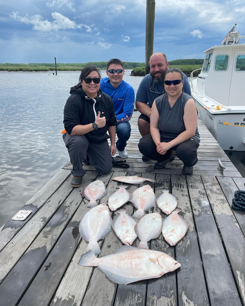 A group of 4 people enjoying a fishing trip in Belmar
