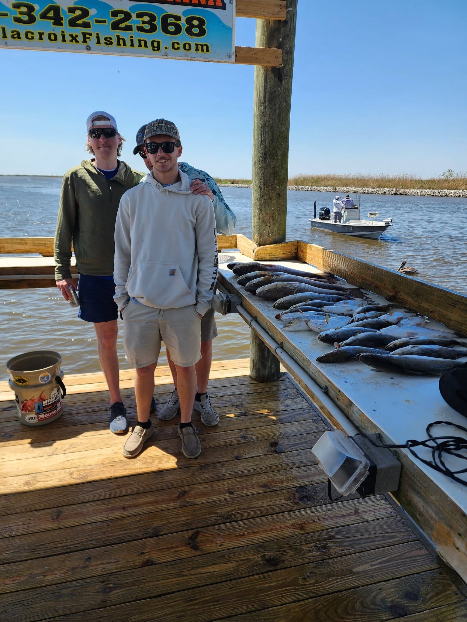 Fishing charter success with multiple fish displayed on cleaning station dock in Hopedale Louisiana