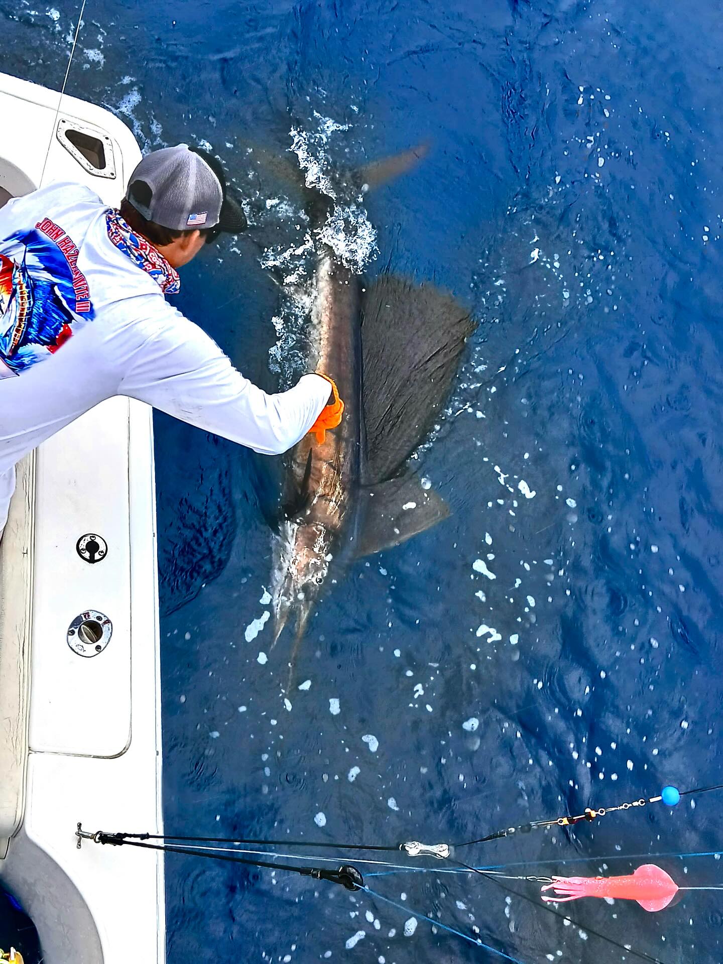 An angler holding a freshly caught fish in Herradura