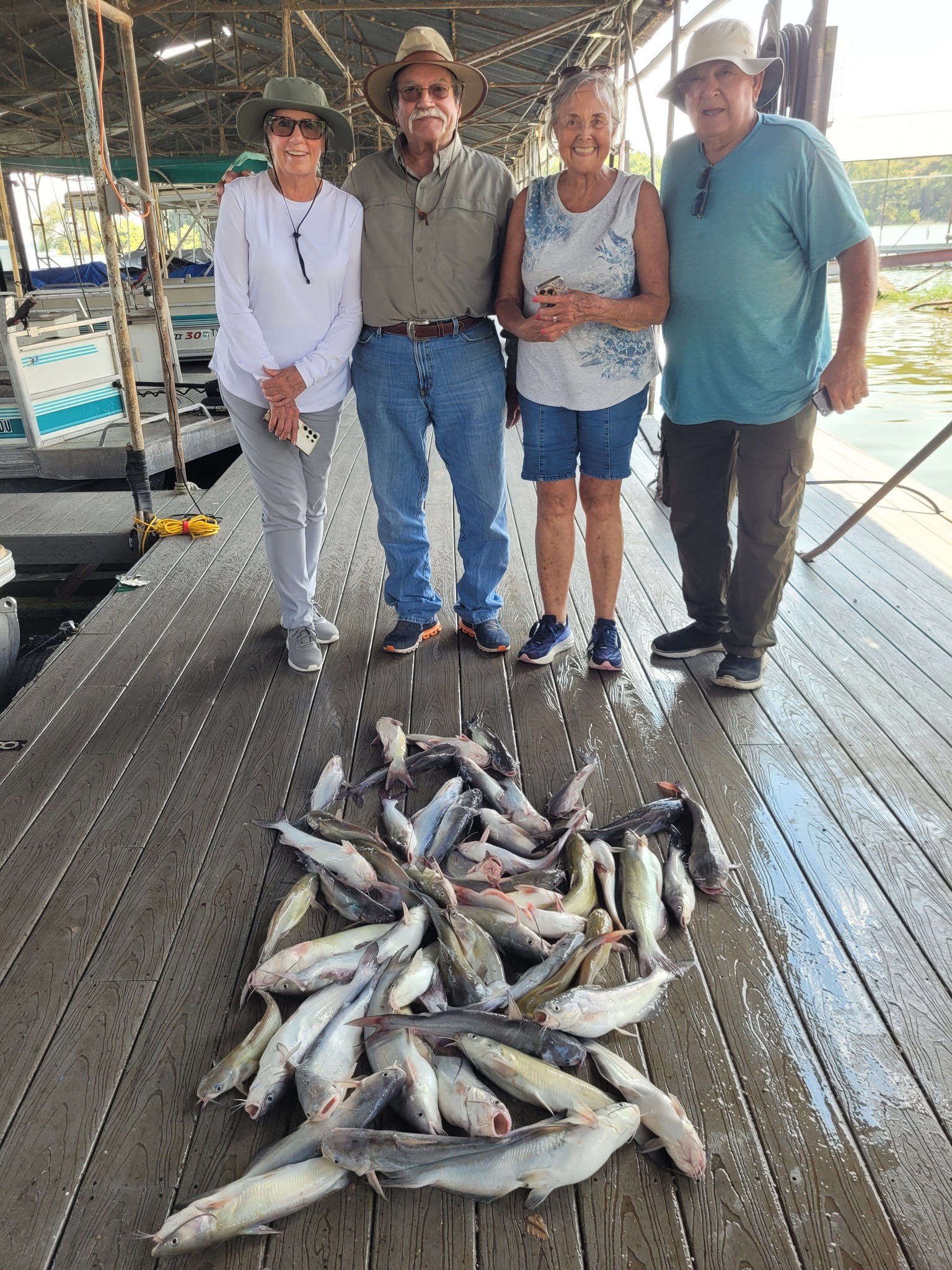 Large catch of channel catfish displayed on wooden dock at West Tawakoni TX marina