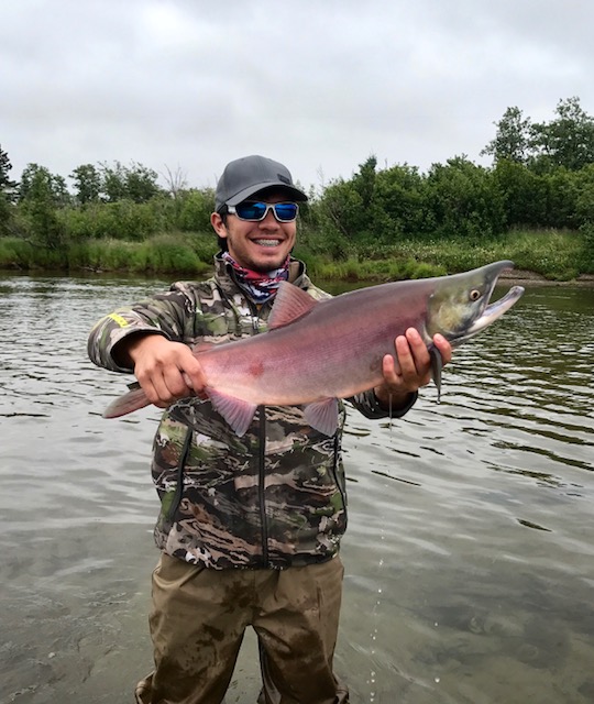 Angler landing a 19-inch fish in Alaska