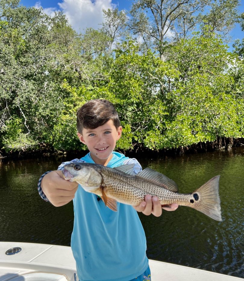 Angler holding a large redfish in Goodland