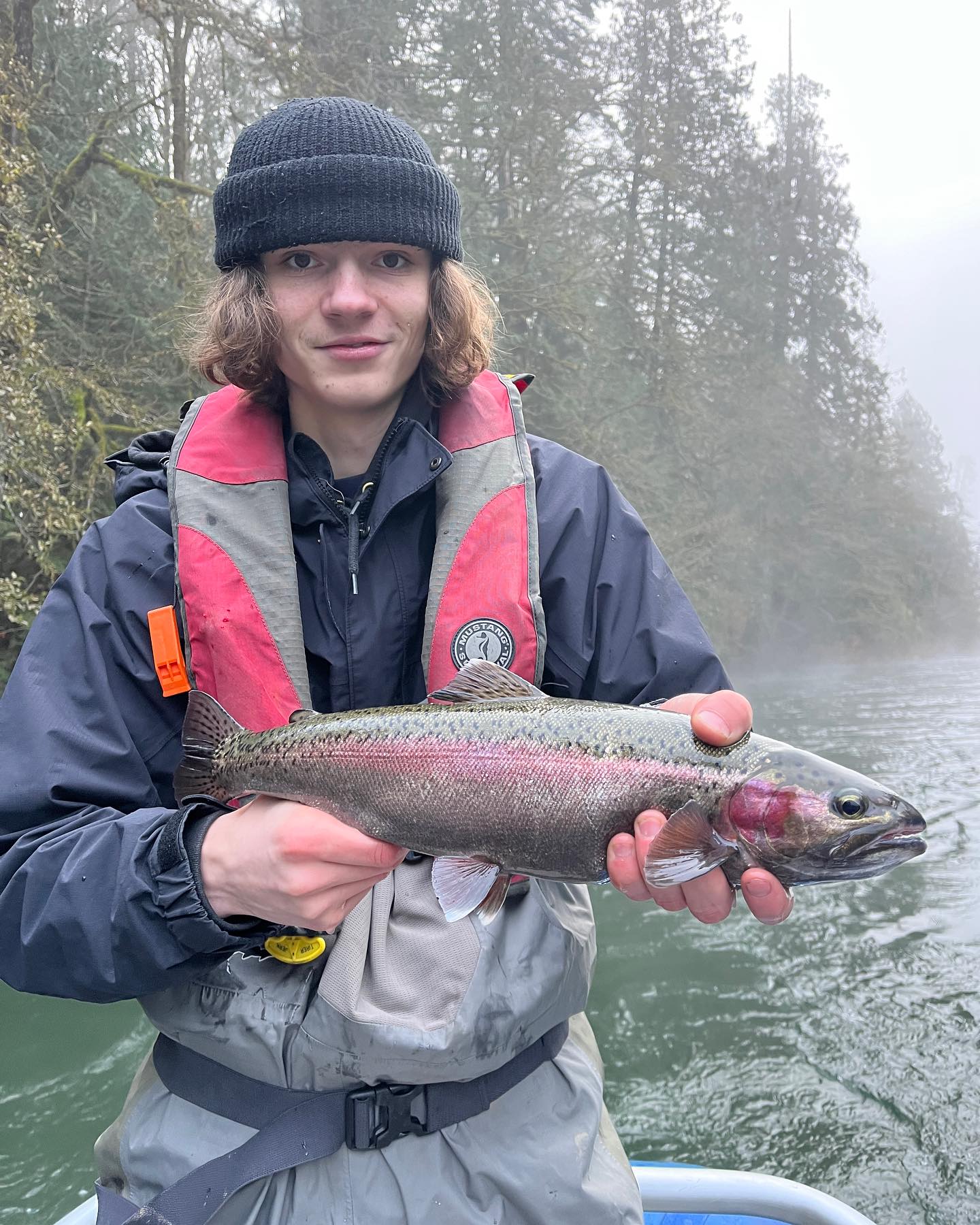 Photograph of a person fishing for a rainbow trout in Lake Cowichan