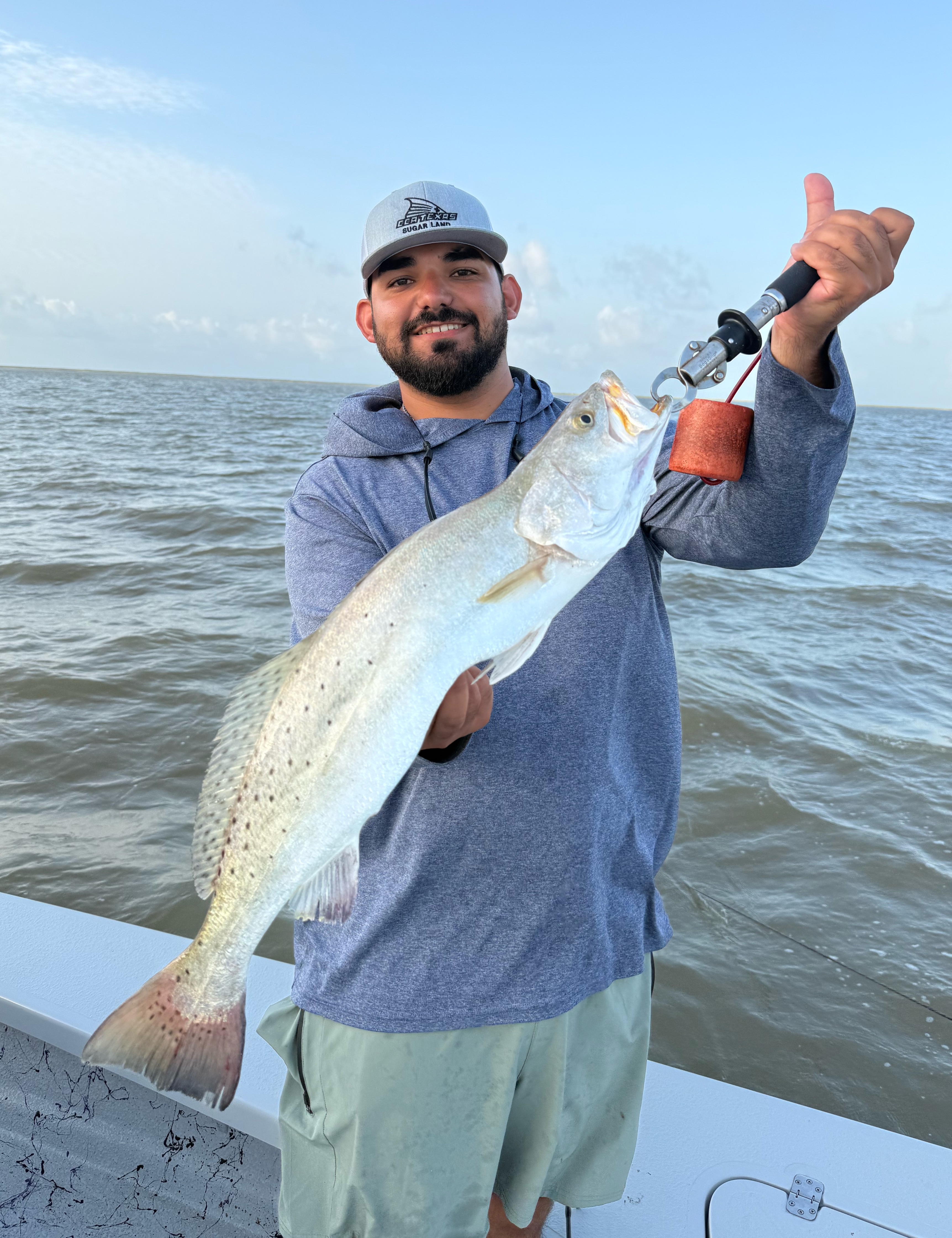 A fisherman catches a spotted weakfish in Matagorda, Texas.