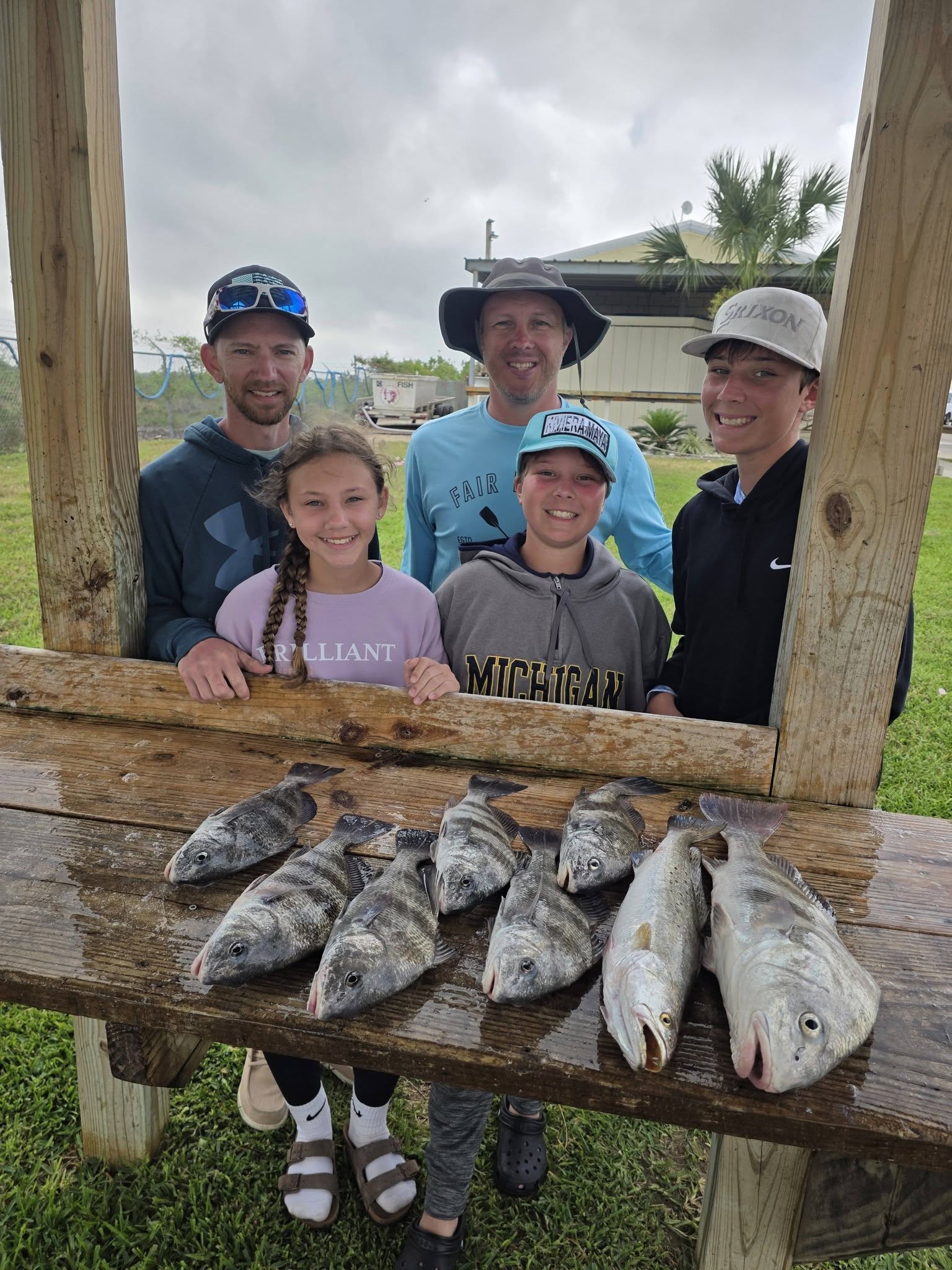Fresh caught black drum and speckled trout displayed on wooden cleaning table in Texas City TX