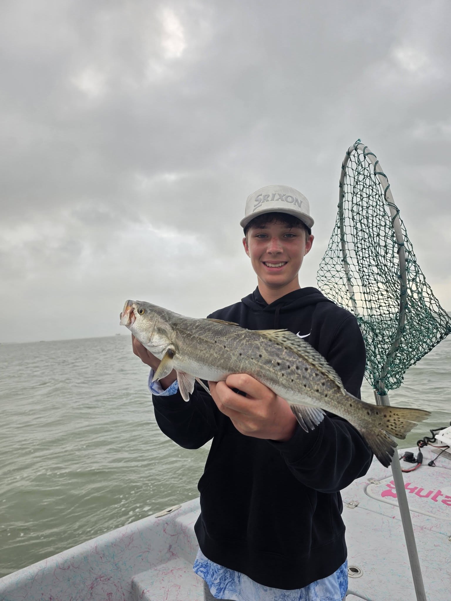 Speckled trout caught fishing in Texas City TX with landing net on boat