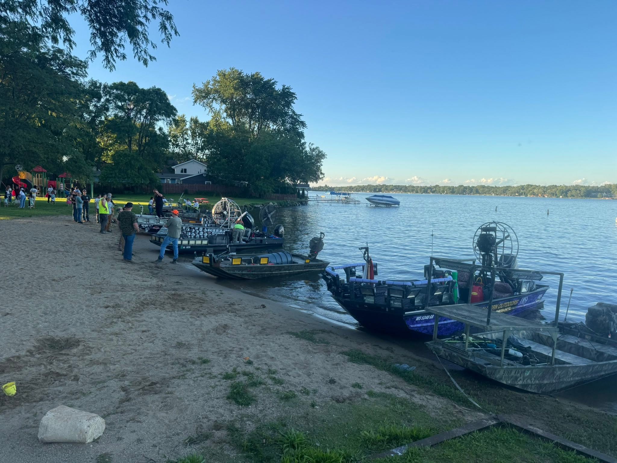 Airboat fleet lined up on sandy shore at lake in Delavan Wisconsin for fishing expedition
