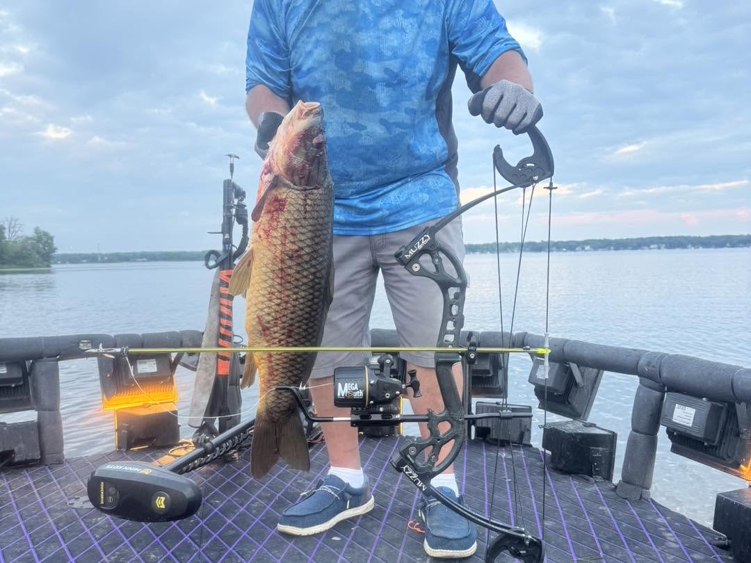Large fish caught using bow fishing equipment on boat deck in Delavan Wisconsin