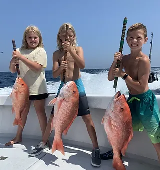 Three anglers holding their fishing rods by the water in FL