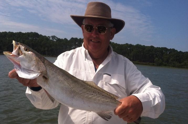 Two people fishing in Apalachicola with a 17-inch fish