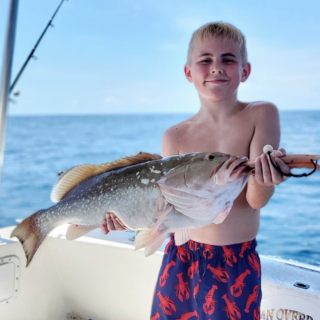 Fisherman holding a 21-inch fish in FL