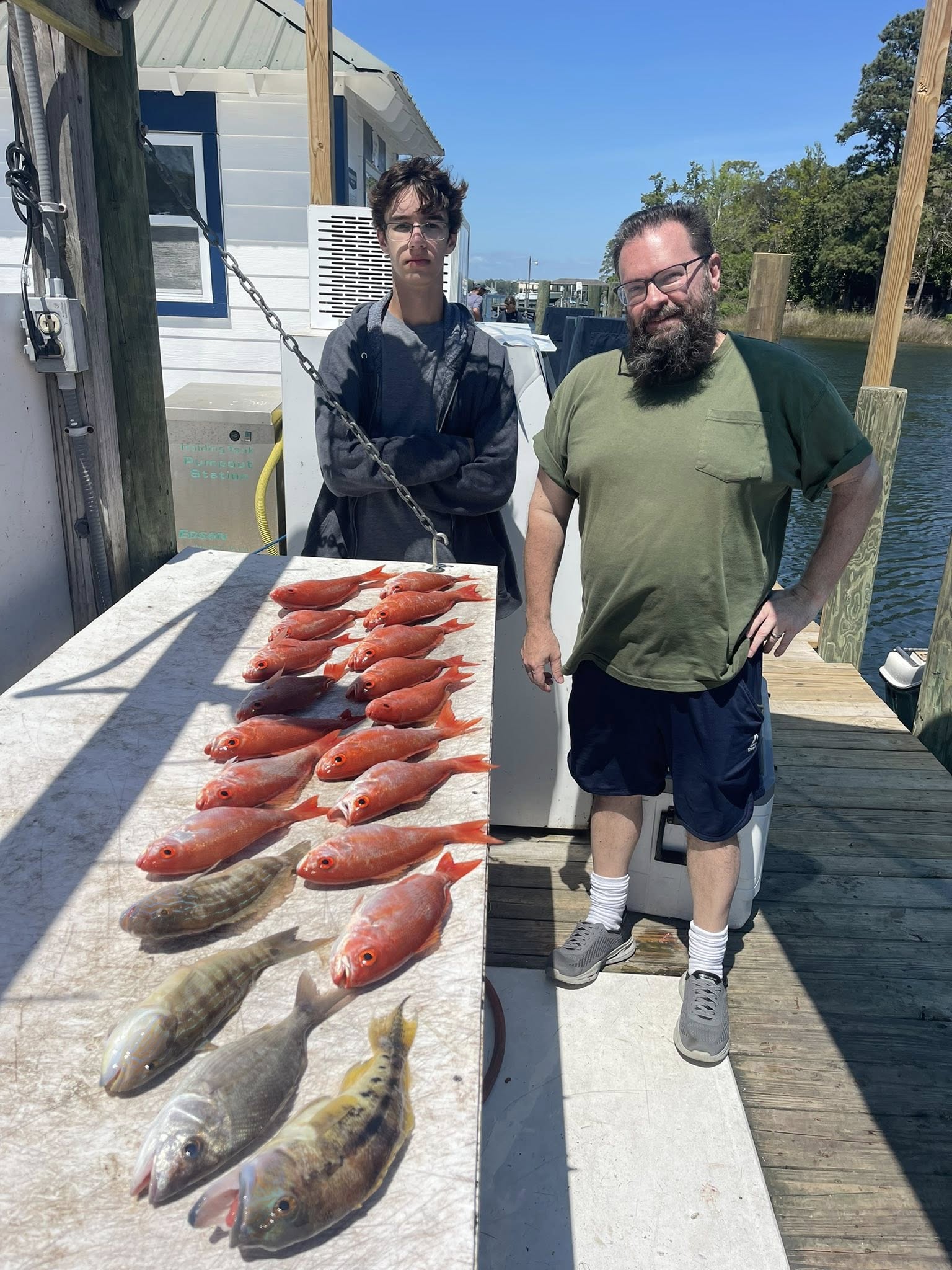 Fresh caught sand perch and other fish displayed on boat dock in Niceville FL