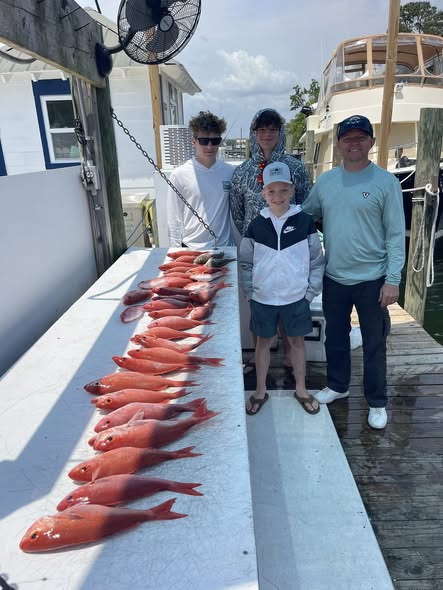 Fresh caught red snapper lined up on fishing boat deck in Niceville FL