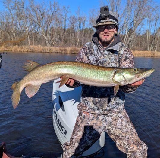 Angler holding a muskellunge fish in Mosinee