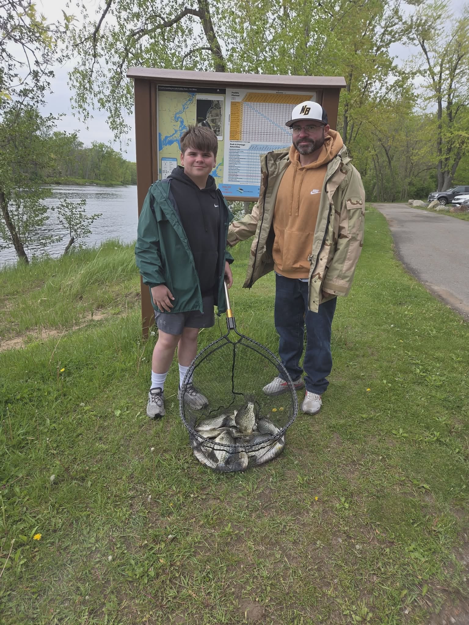 Successful fishing trip in Mosinee WI with catch displayed in wire basket near lake
