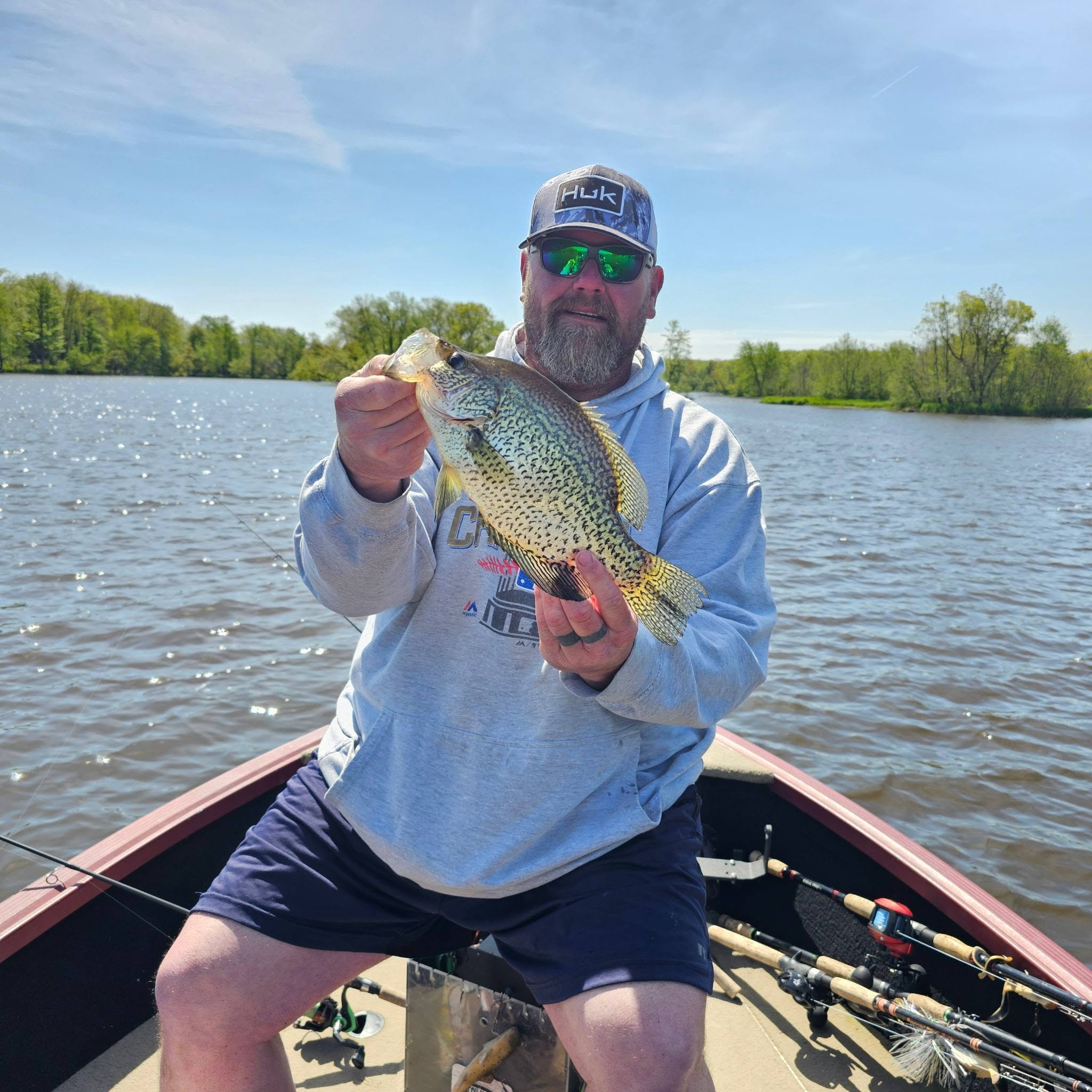 Angler holding freshly caught crappie while fishing from boat in Mosinee Wisconsin