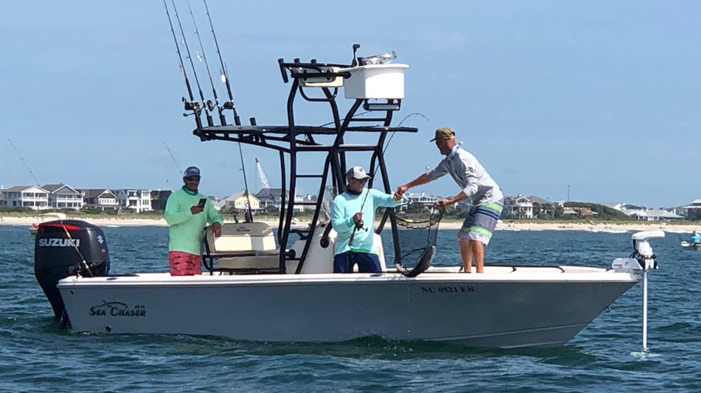 Three people enjoying a fishing and hunting trip at Wrightsville Beach