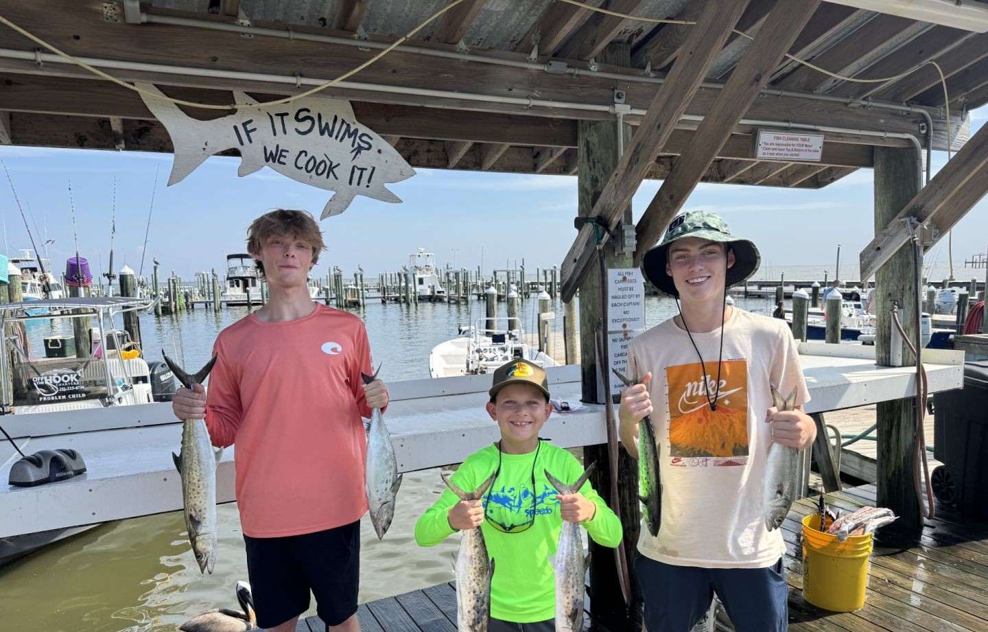 A group of 3 people fishing for 4 spanish mackerel in an unknown location