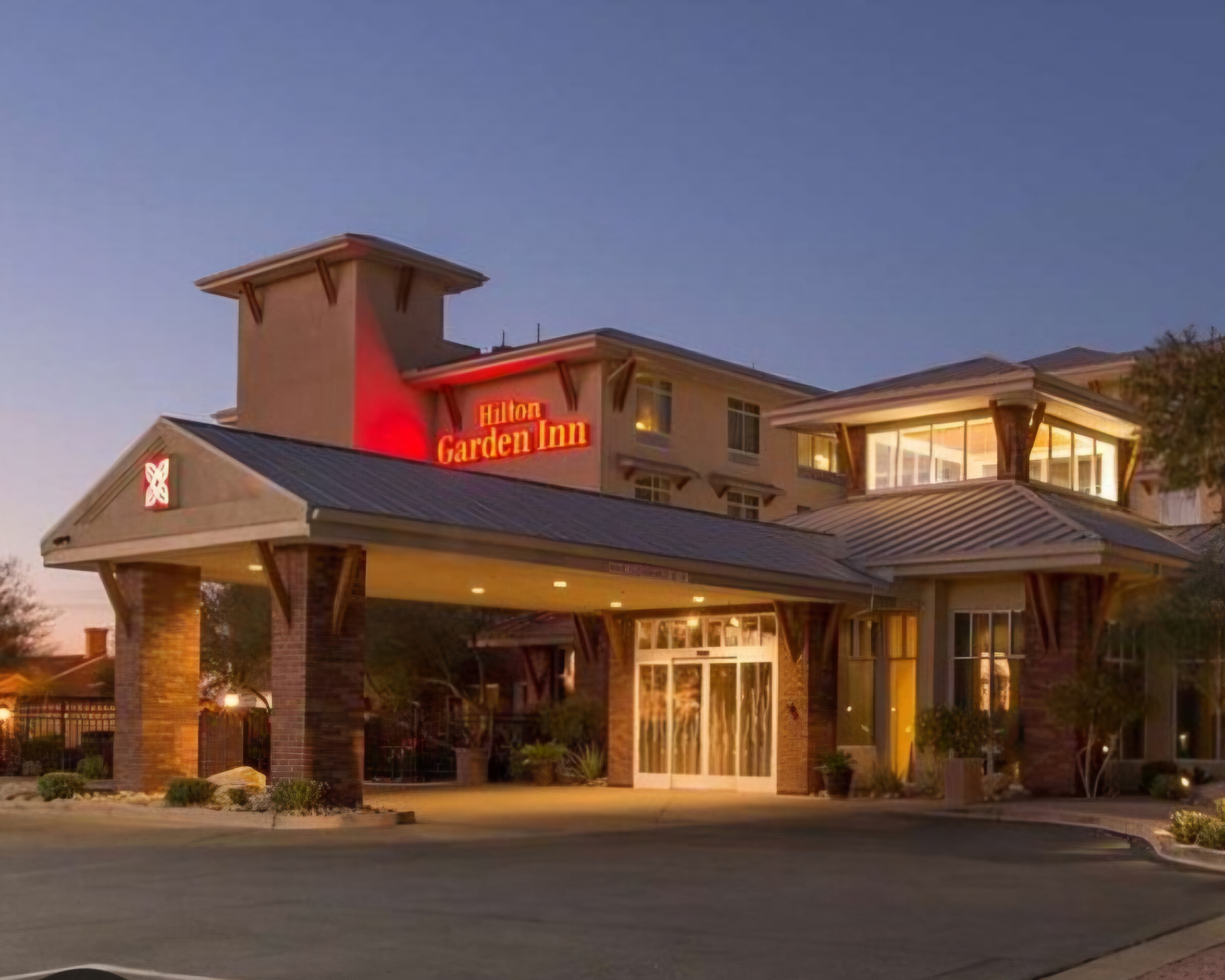 Hilton Garden Inn hotel exterior at dusk in Yuma Arizona with illuminated entrance and modern architecture