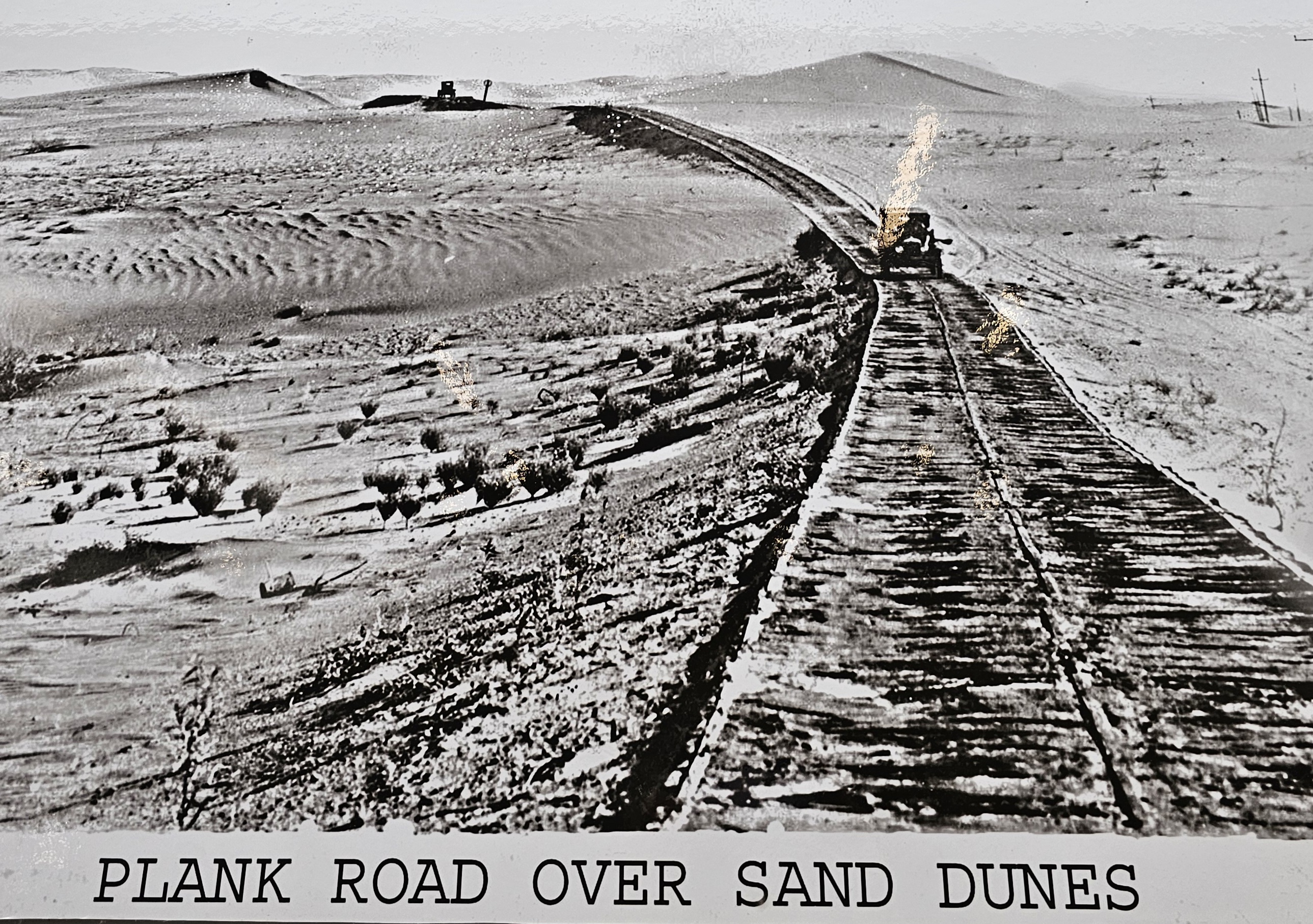 Historic plank road crossing sand dunes in Yuma Arizona desert landscape