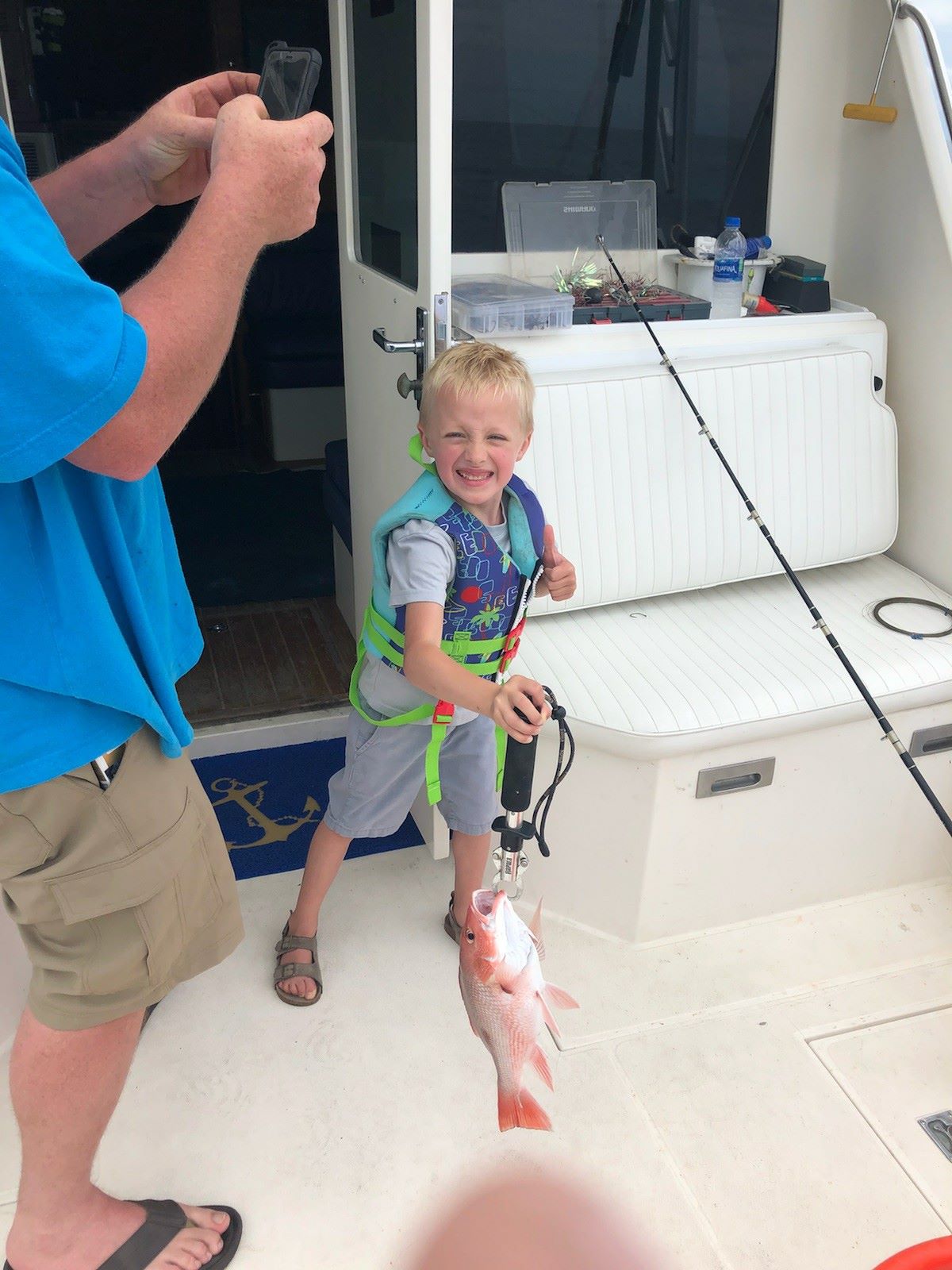 Fisherman holding a 12-inch catch in Panama City