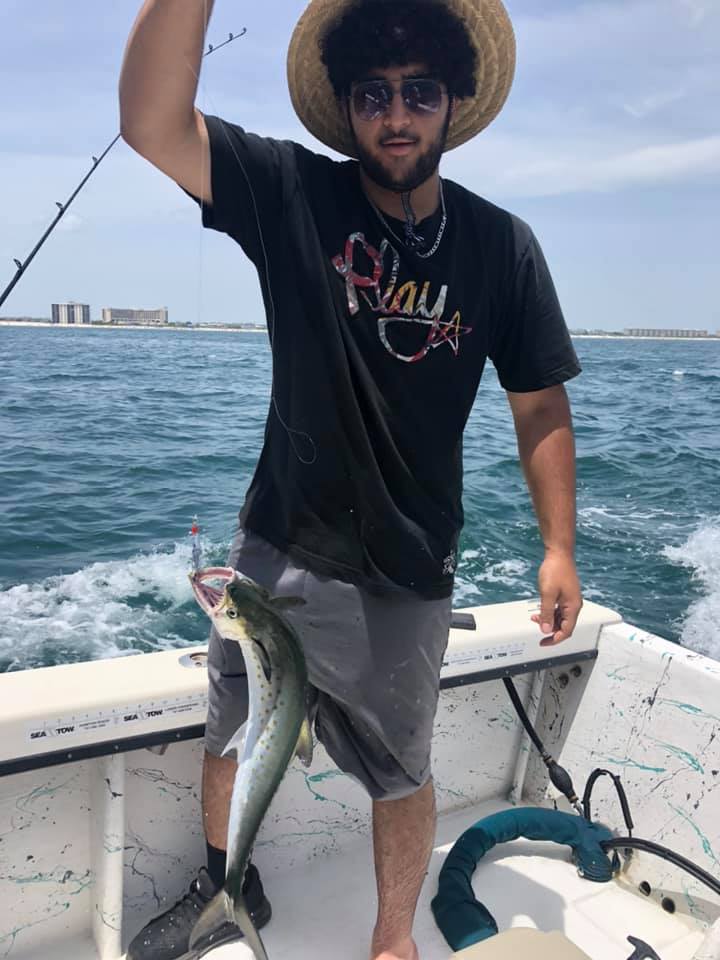 Fisherman holding a 15-inch fish at Wrightsville Beach