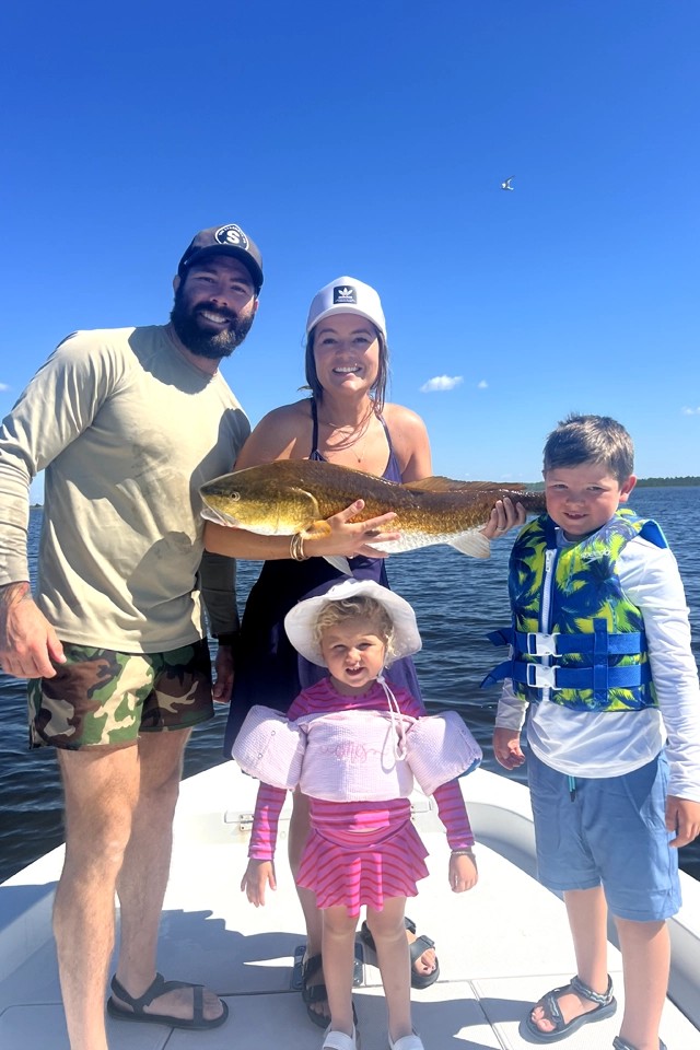 Family fishing trip in Freeport FL with fresh caught redfish on boat