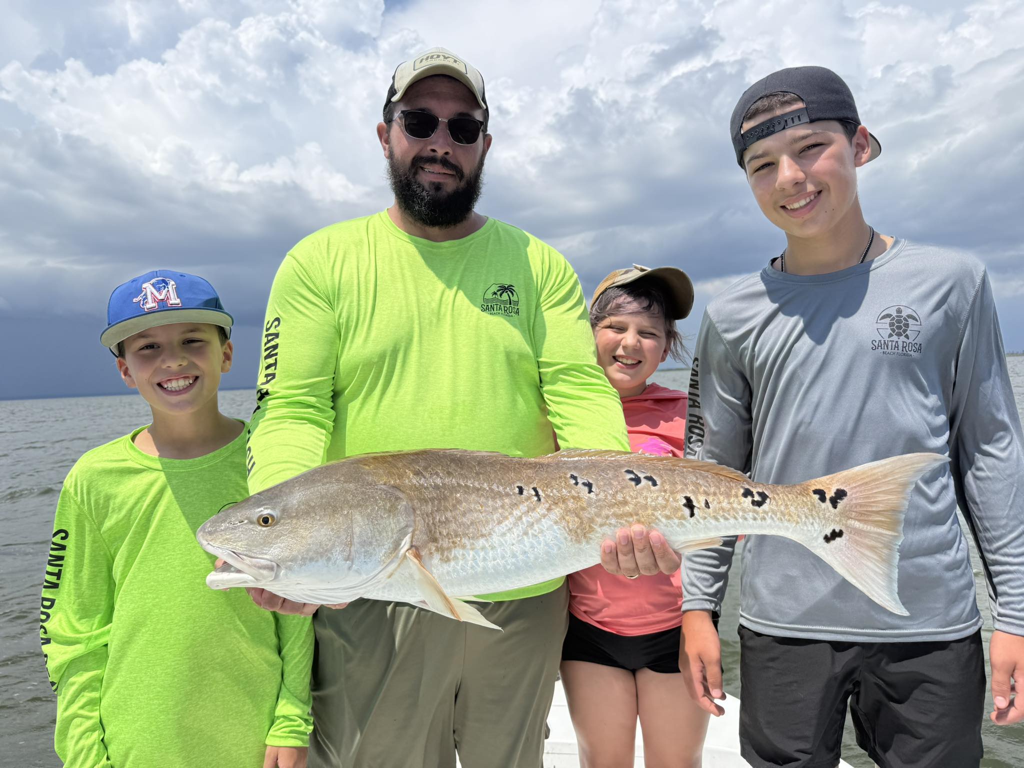 Kids fishing with captain on Choctawhatchee Bay inshore charter boat in Freeport, Florida