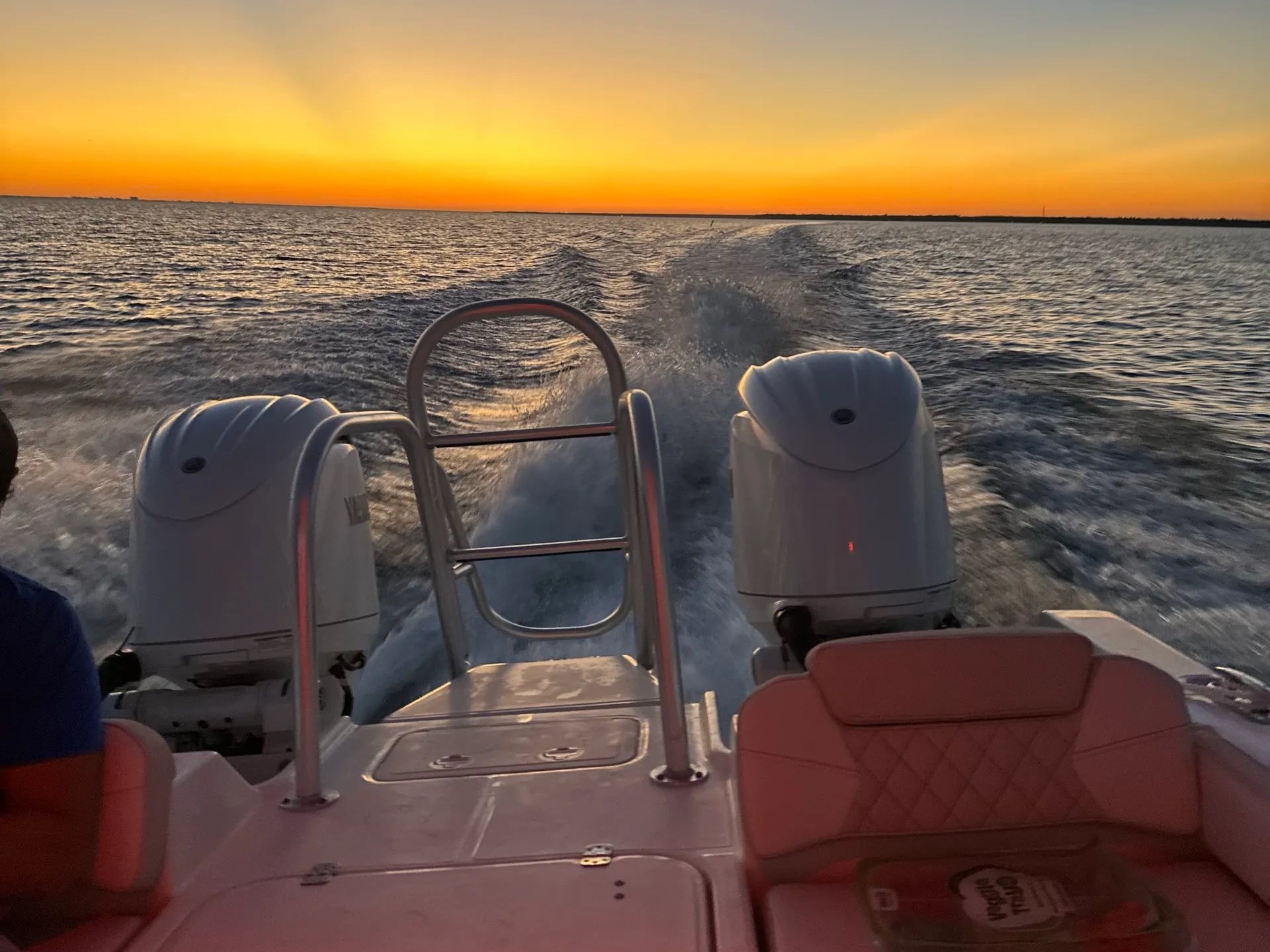 Baytowne Marina sunset fishing charter boat with guests enjoying inshore fishing at golden hour