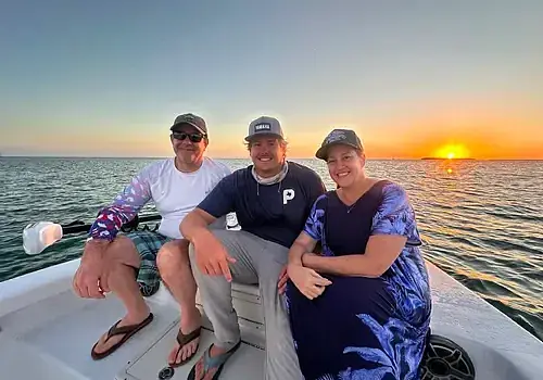 Key West sunset cruise boat with passengers viewing golden hour skyline from calm waters