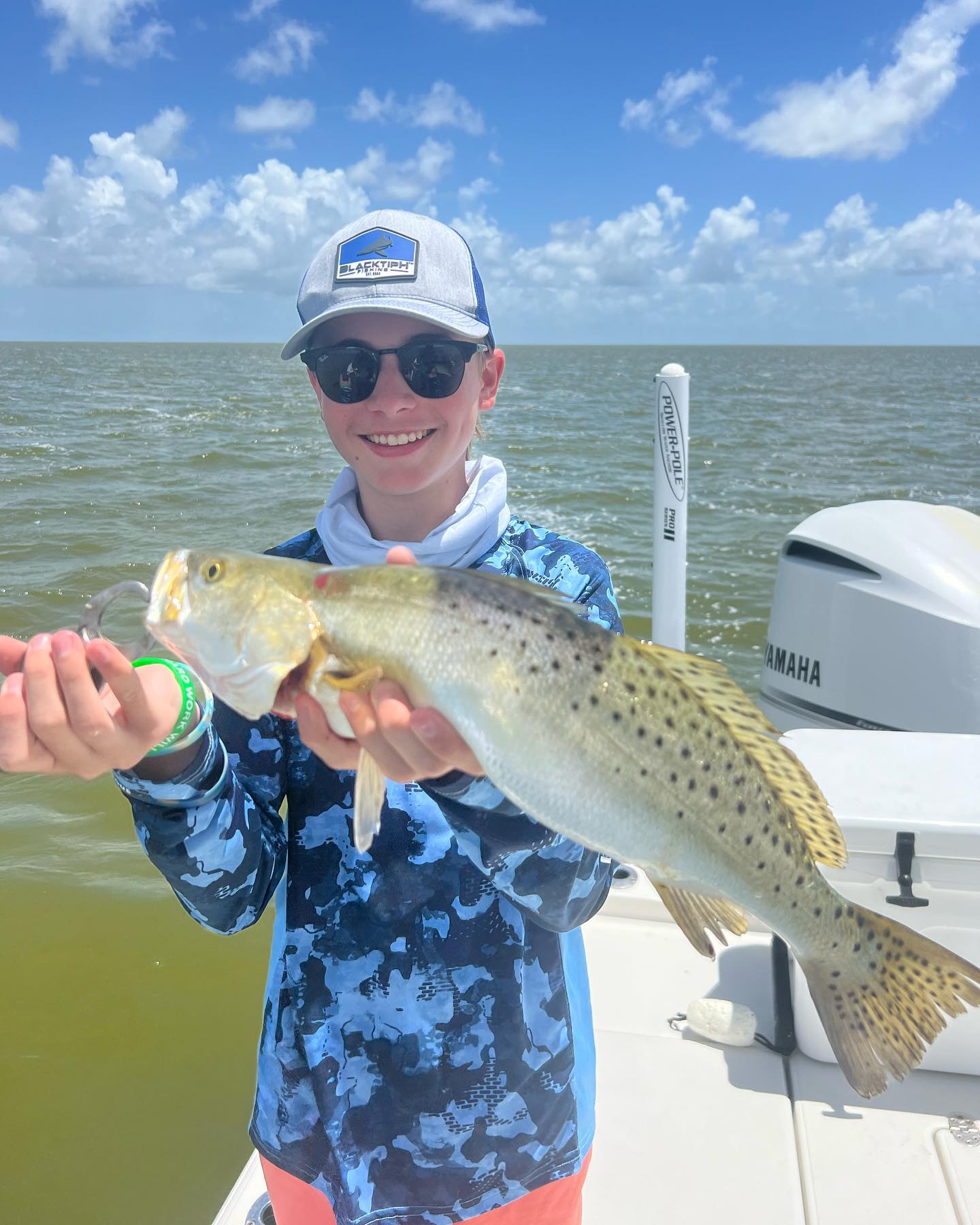Angler with a spotted weakfish, 21 inches, in FL