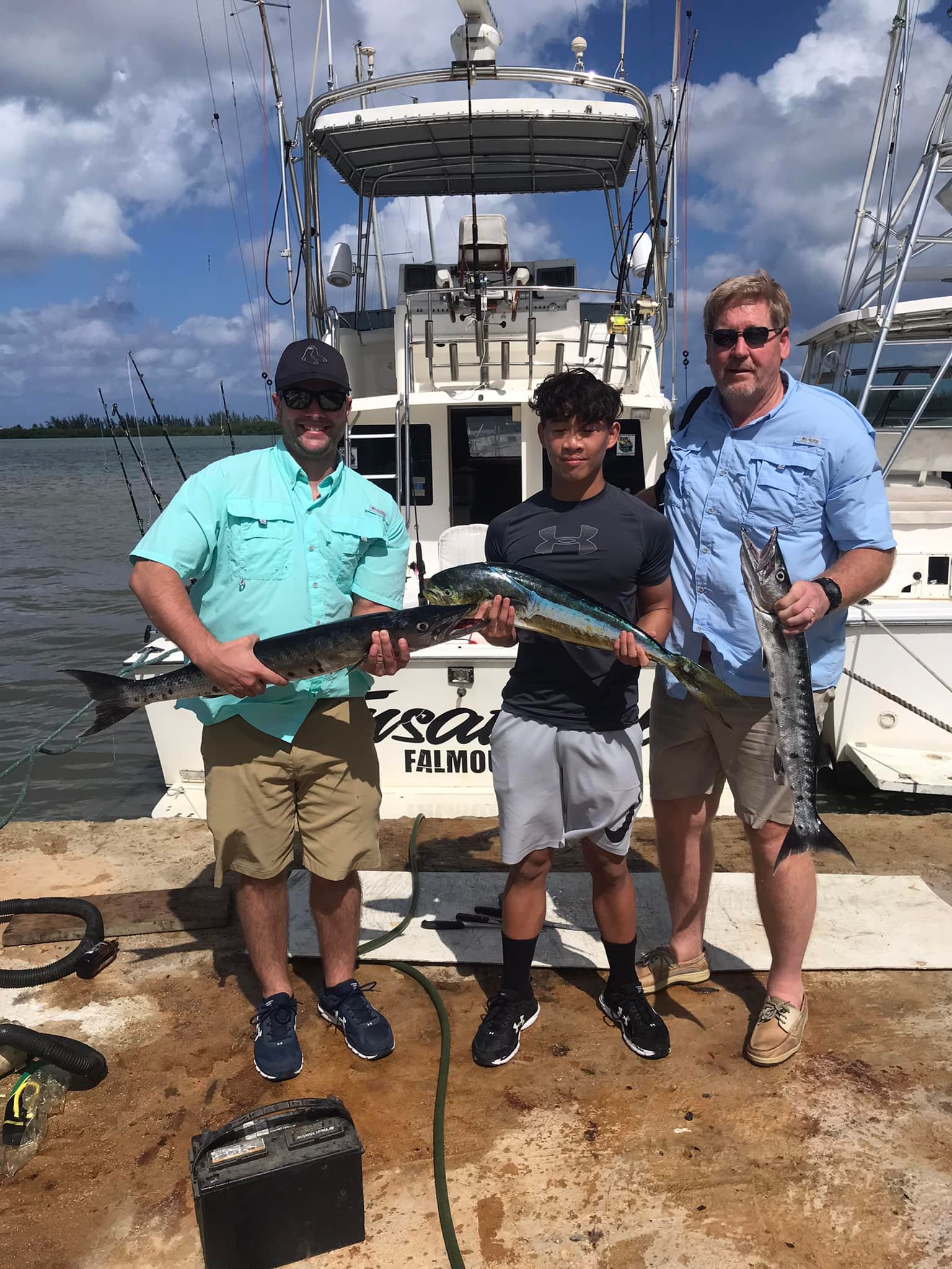 Fishing charter displaying Great Barracuda and Mahi Mahi catch on dock in Falmouth