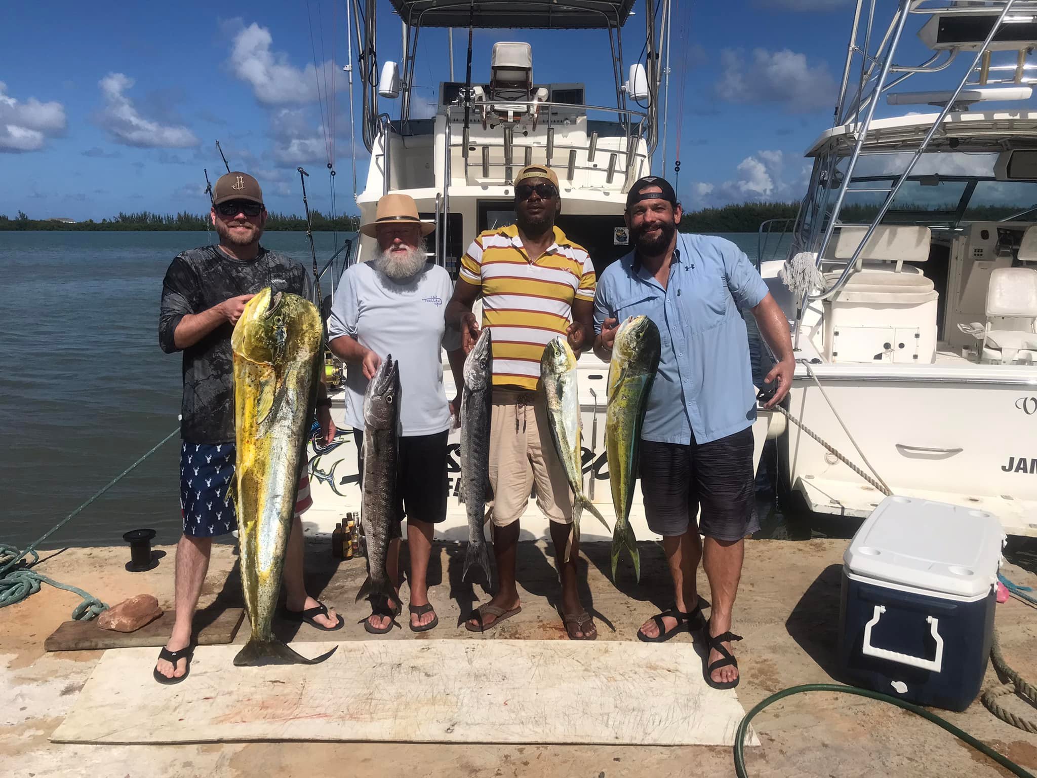 Successful fishing trip in Falmouth showing caught Mahi Mahi and Great Barracuda on dock