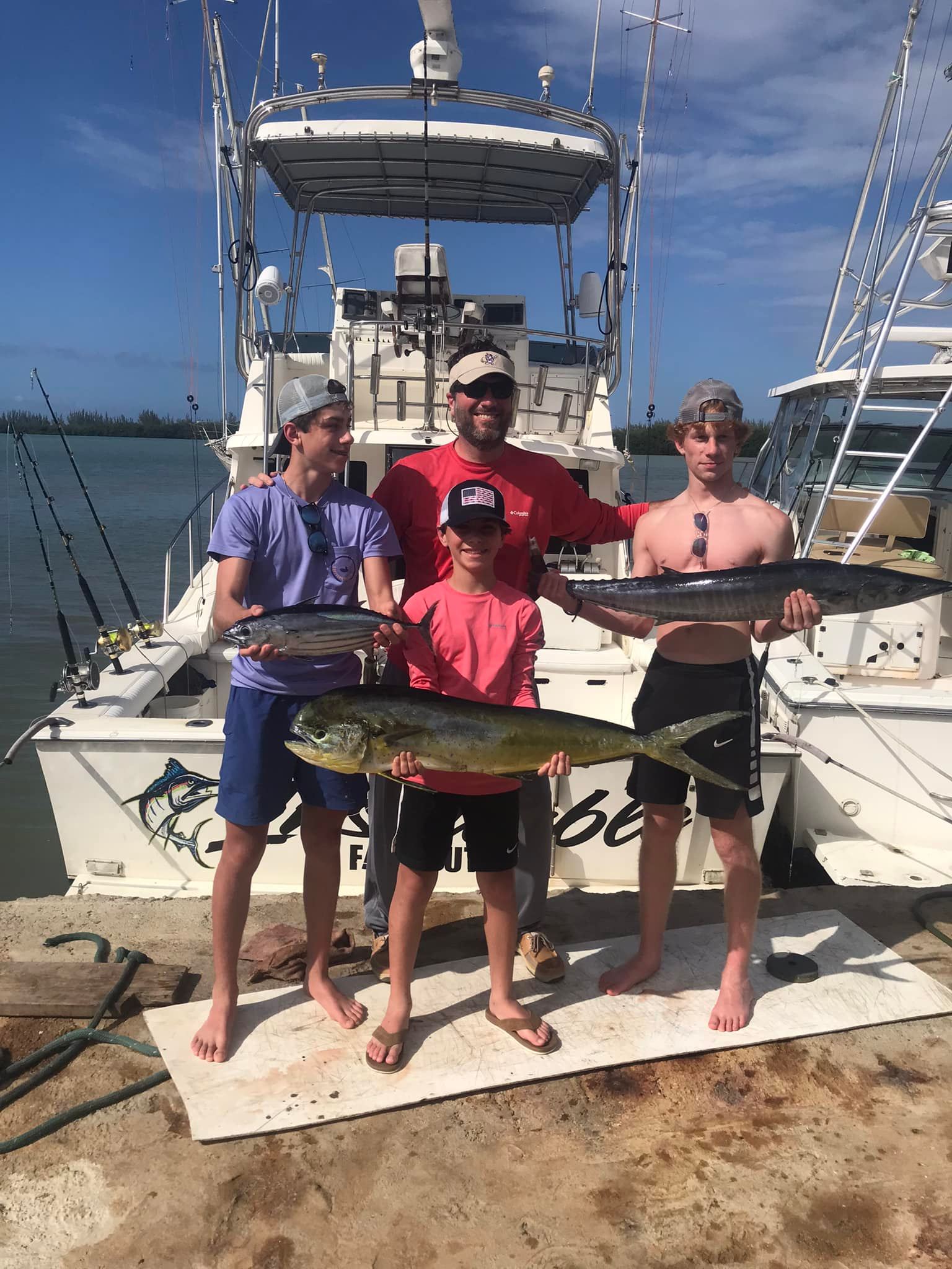 Successful fishing trip in Falmouth with fresh caught Mahi Mahi, Wahoo, and Skipjack Tuna displayed on dock