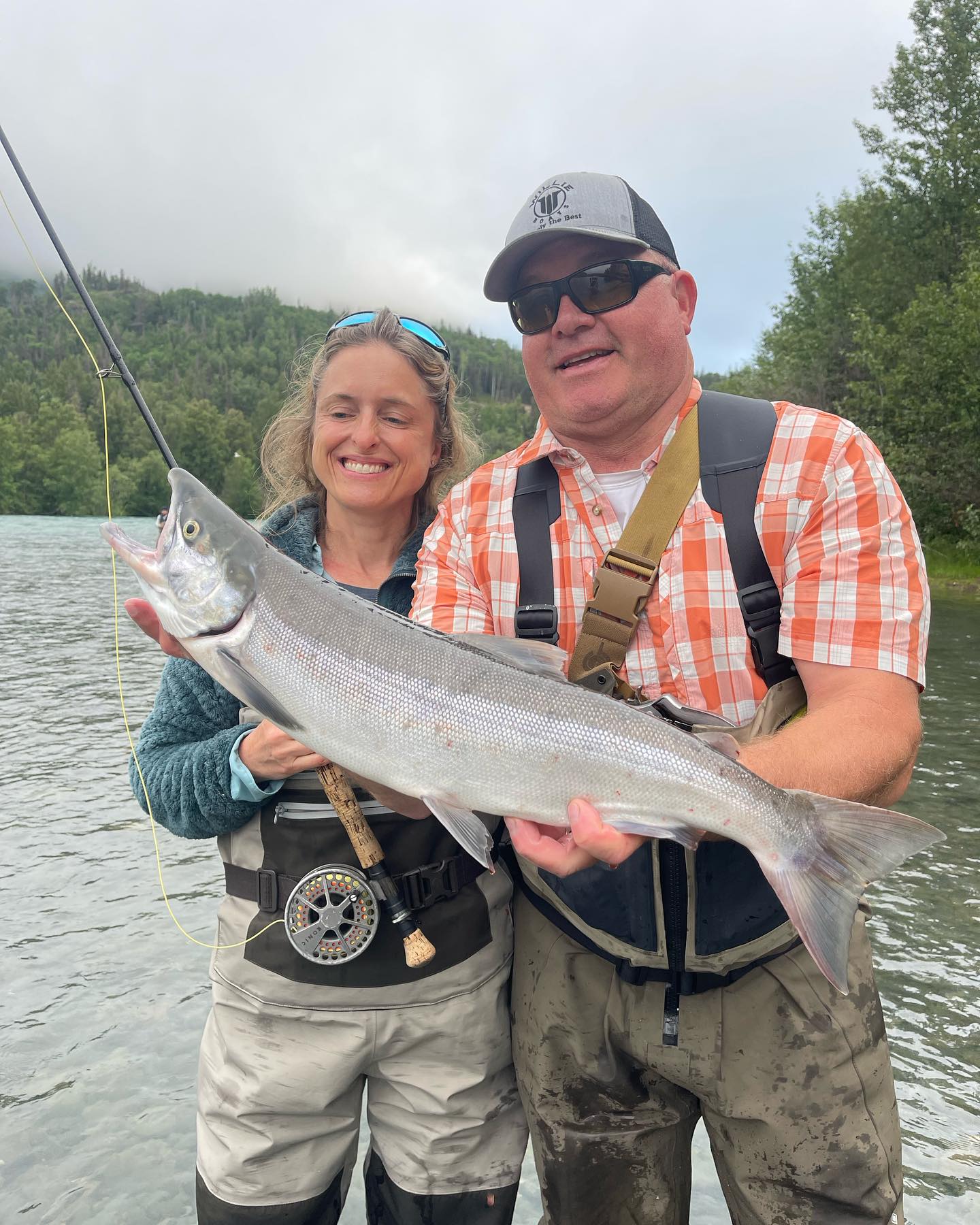 Coho salmon caught by two people in Cooper Landing