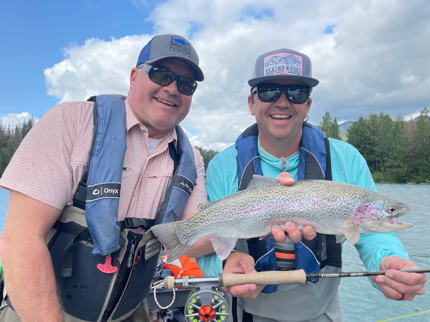 Angler holding a beautiful rainbow trout in Alaska