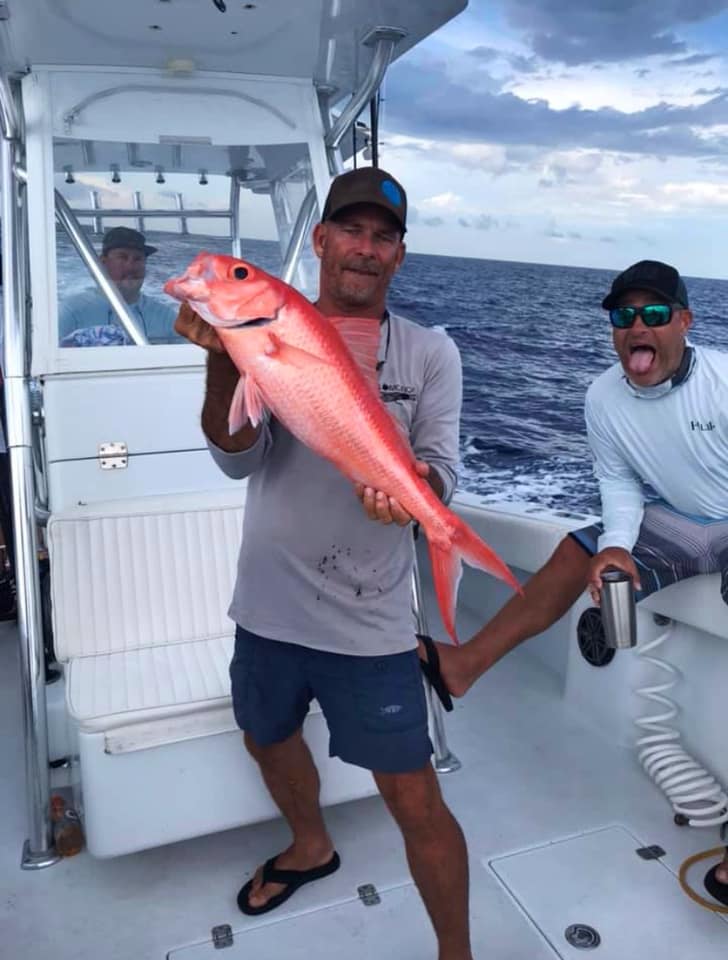 A group of 3 people fishing at Pompano Beach