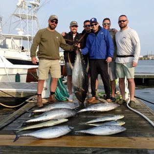 Two anglers display their catch on a sunny day in VA