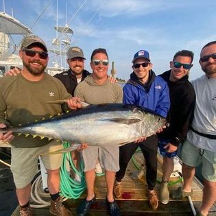 Fisherman holding a large greater amberjack in VA