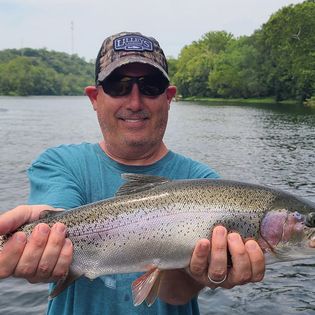A fisherman with a rainbow trout catch in Branson
