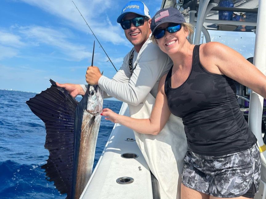 A fisherman holds a massive Atlantic Sailfish catch in Marathon, Florida.