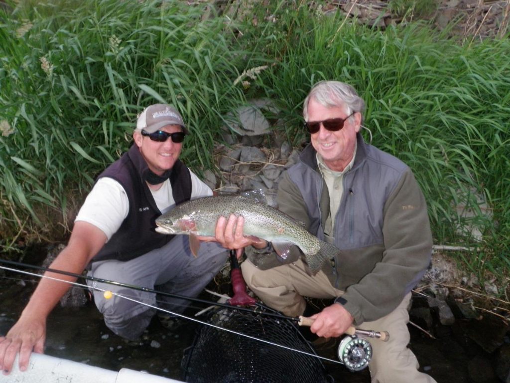 Angler proudly holding a 20-inch rainbow trout in Ellensburg