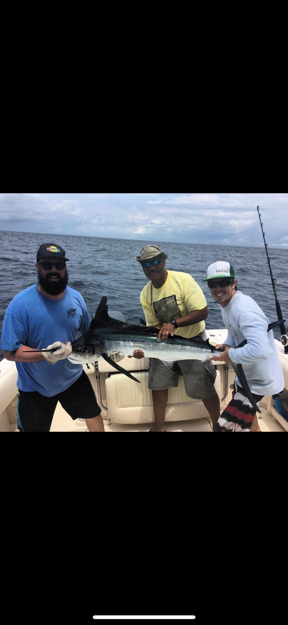 A fisherman holds a blue marlin in Wanchese