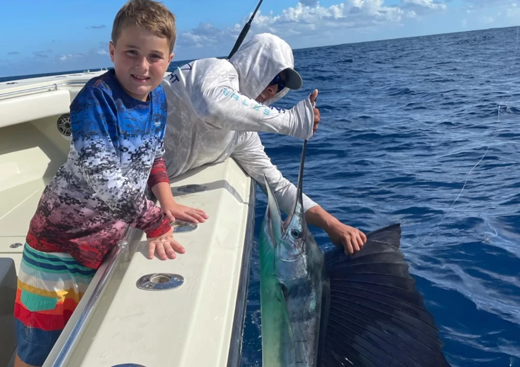A fisherman catching a massive Atlantic Sailfish in West Palm Beach