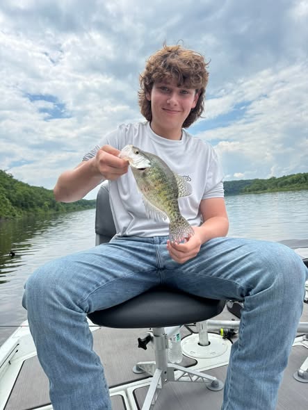 Angler holding freshly caught bass while fishing in Pittsburg MO