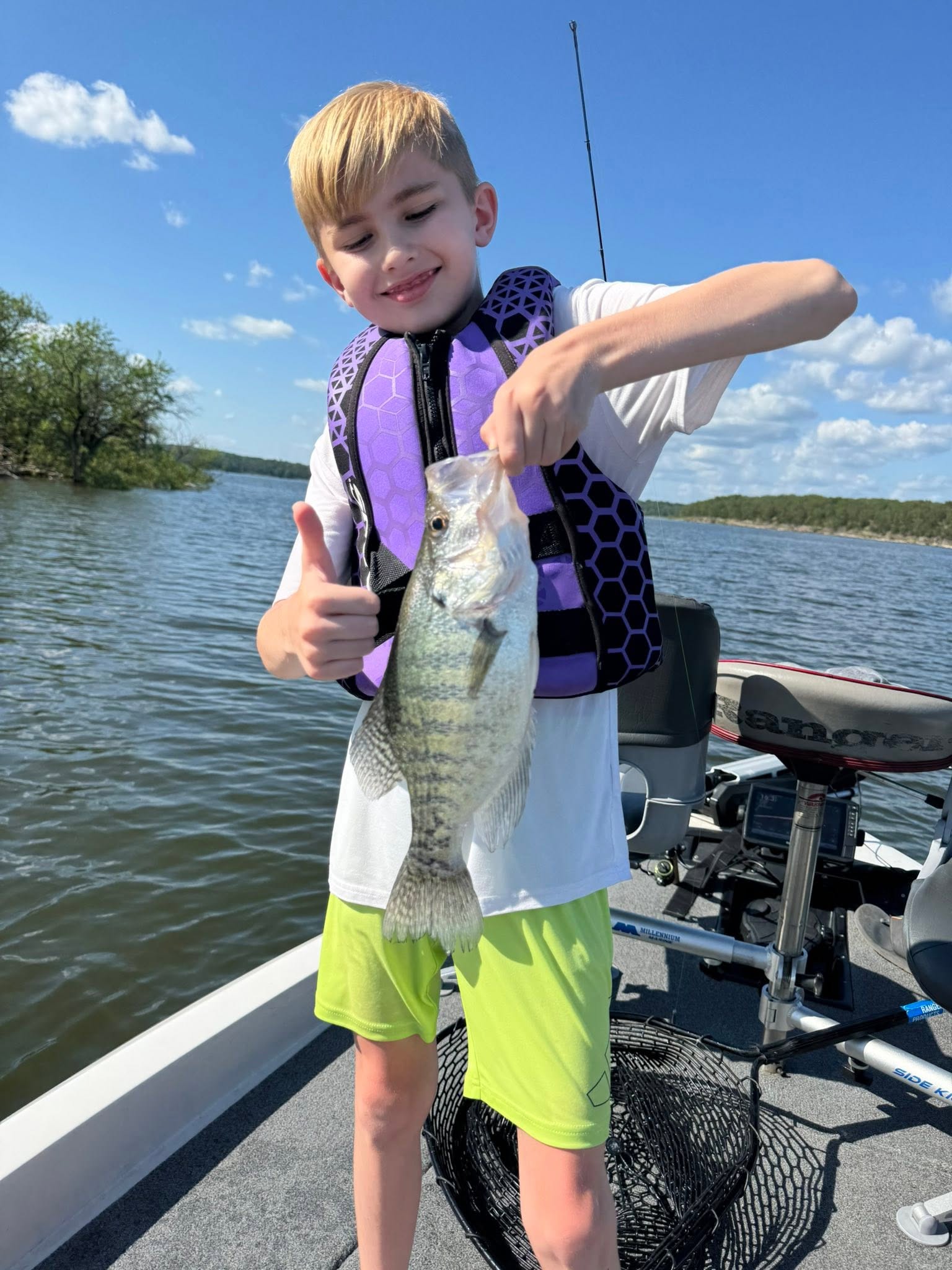 Bass caught while fishing in Pittsburg MO displayed on boat deck