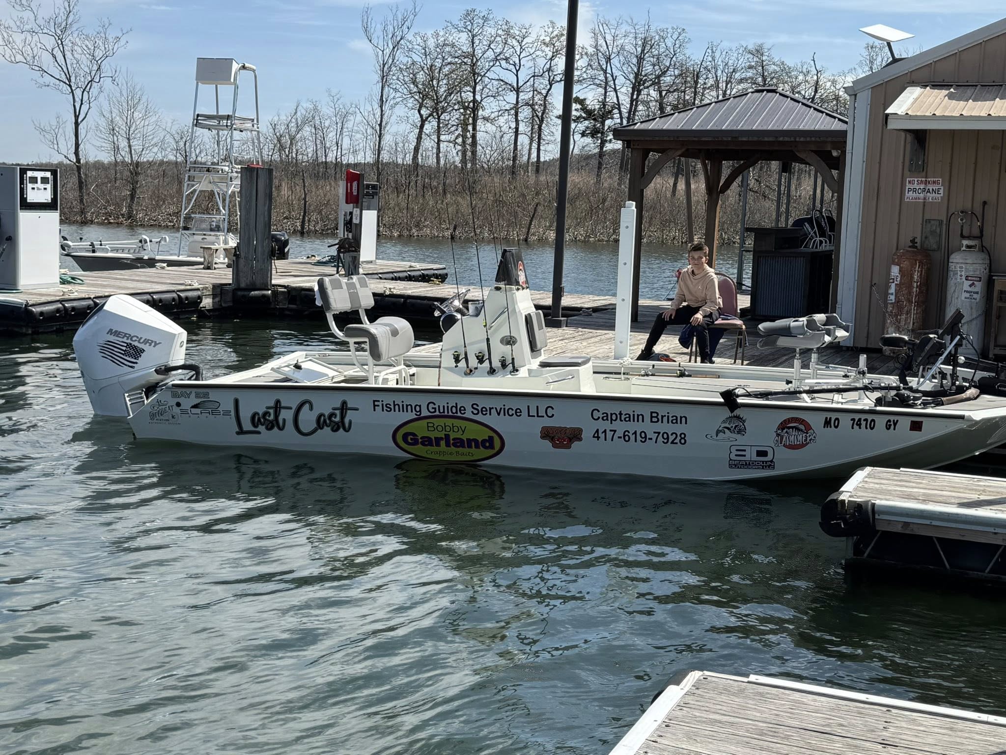 Fishing guide boat 'Last Cast' docked at marina in Pittsburg MO with Mercury outboard motor