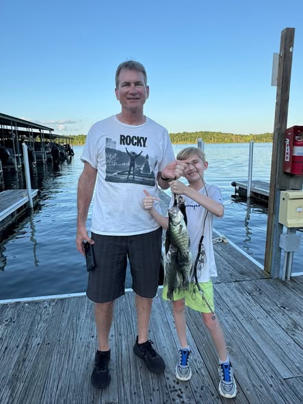 Fresh caught bass displayed on wooden dock at marina in Pittsburg MO