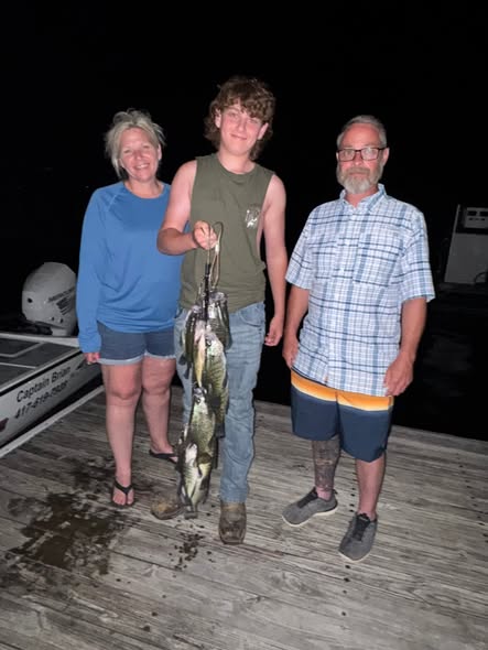 Successful fishing trip in Pittsburg MO showing fresh caught fish on wooden dock at night