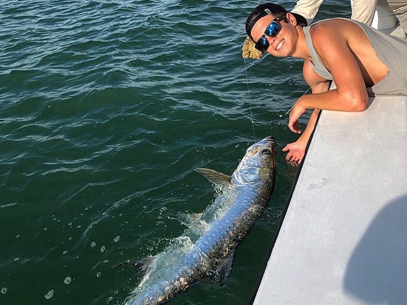 Tampa Bay tarpon fishing charter boat with captain and anglers targeting Florida game fish